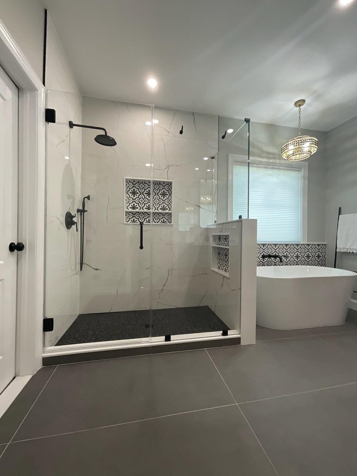 Custom frameless shower glass enclosure installed in a bright Tampa master bathroom